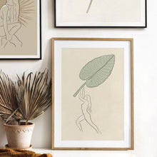 Load image into Gallery viewer, Nude beach girl with tropical palm leaf art print by Megan Heloise
