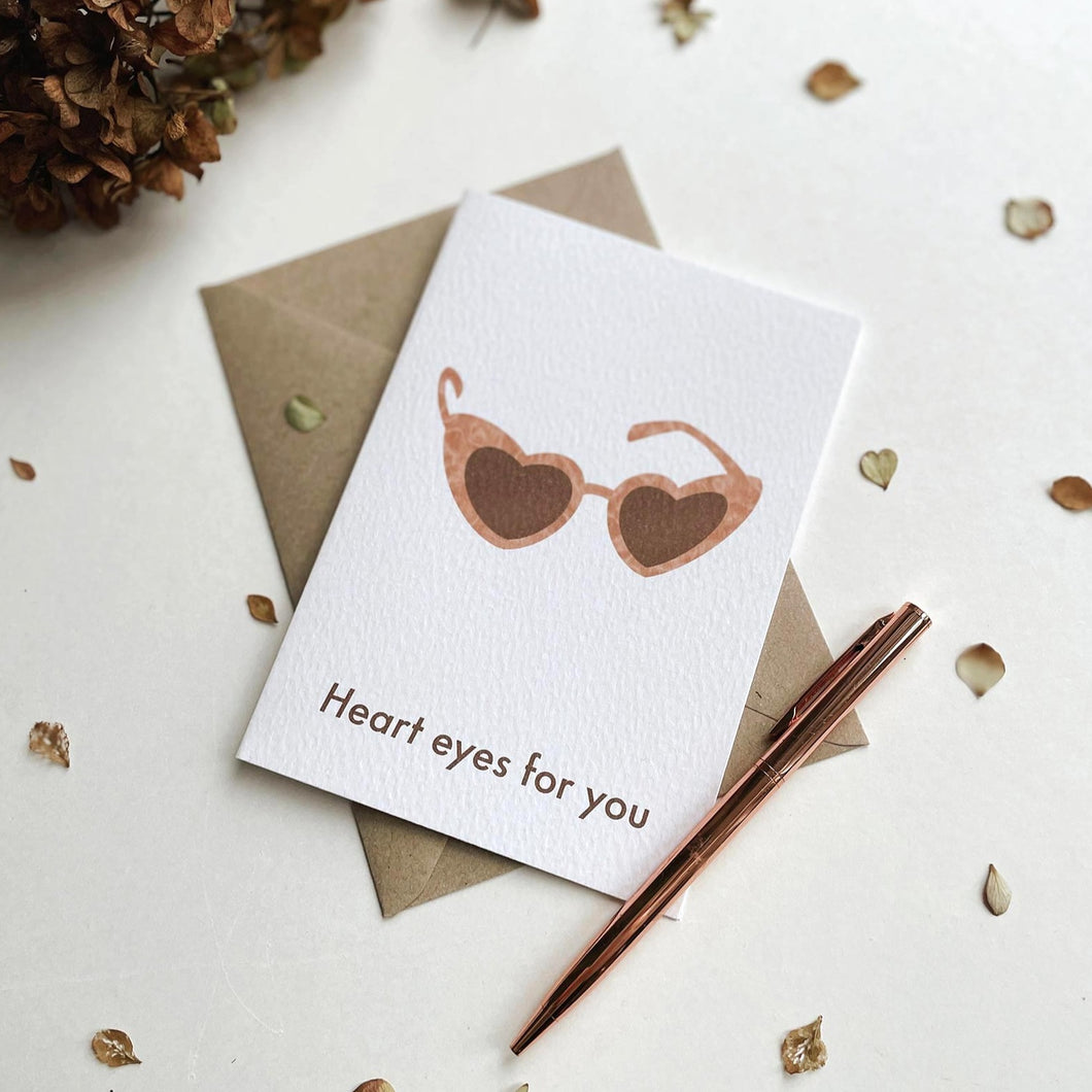 Heart eyes for you heart shaped sunglasses illustrated greeting card with natural kraft envelope. The illustrated retro sunglasses card by Megan Heloise is simple and elegant, ideal for your lover, Galetine, Valentine or as a birthday or anniversary card.